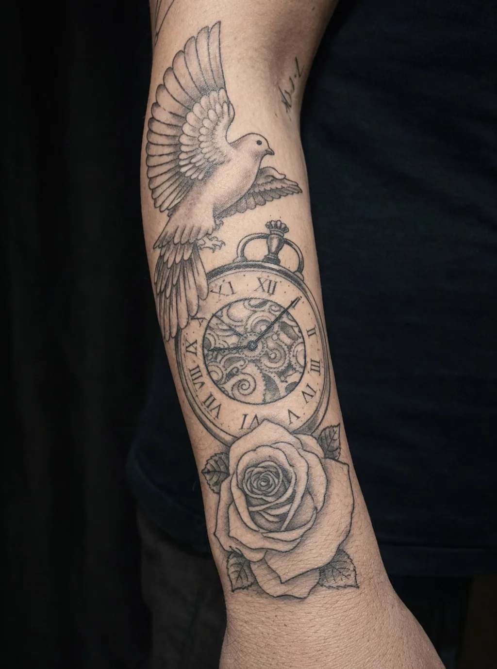 Black and grey forearm tattoo of a dove in flight above an ornate pocket watch and a rose